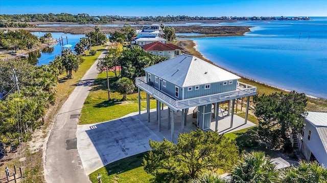 drone / aerial view with a water view and a beach view