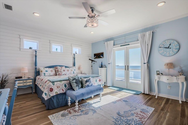 bedroom featuring access to exterior, ceiling fan, french doors, dark wood-type flooring, and a water view