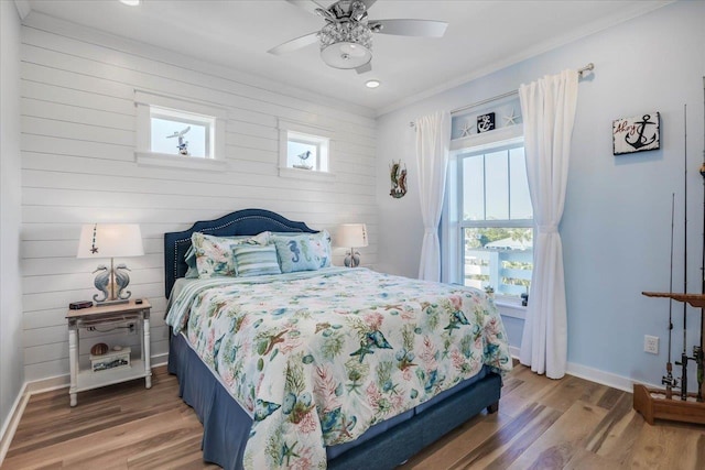 bedroom with ceiling fan, ornamental molding, and hardwood / wood-style flooring