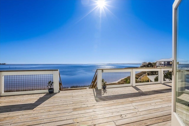 view of dock featuring a deck with water view