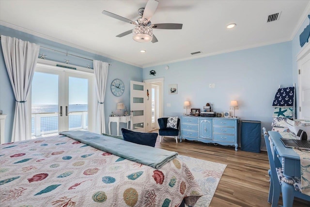 bedroom featuring access to exterior, ceiling fan, crown molding, a water view, and dark hardwood / wood-style floors