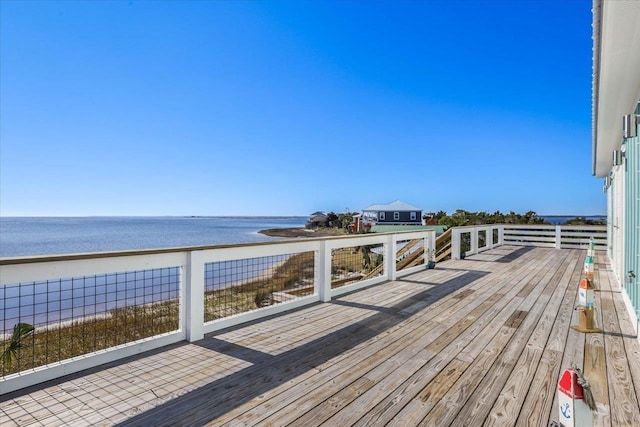 deck featuring a view of the beach and a water view