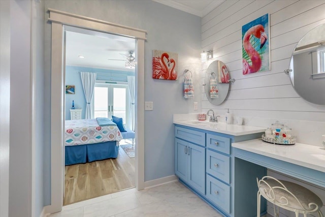 bathroom with vanity, ceiling fan, and ornamental molding