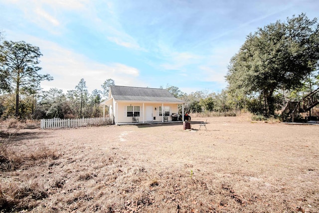 back of house featuring a porch
