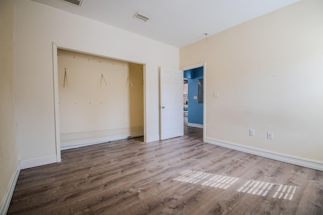 unfurnished bedroom with wood-type flooring and a closet