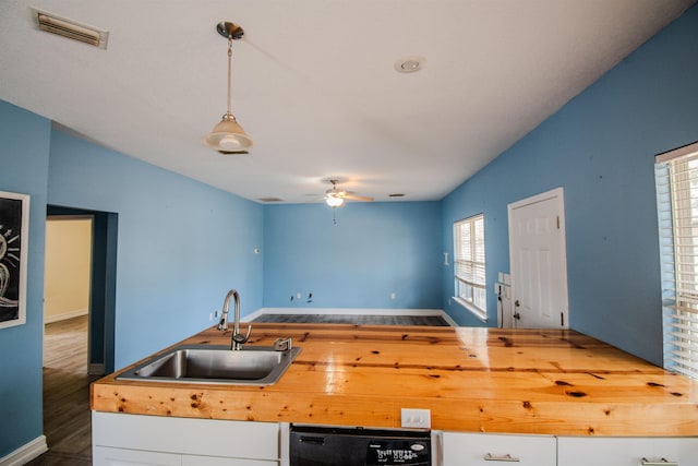 kitchen featuring pendant lighting, sink, wooden counters, dishwasher, and ceiling fan