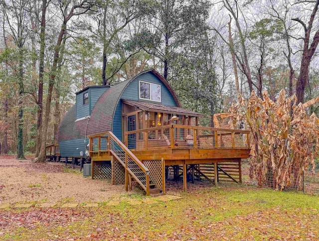 back of house featuring a wooden deck and cooling unit