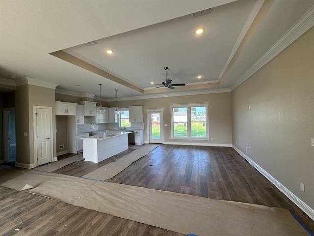 273 Springdale Dr, Crawfordville, FL 32327 - unfurnished living room featuring a tray ceiling, a ceiling fan, dark wood-style floors, crown molding, and recessed lighting