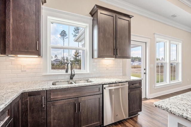 273 Springdale Dr, Crawfordville, FL 32327 - kitchen with dishwasher, dark brown cabinets, ornamental molding, dark wood finished floors, and decorative backsplash