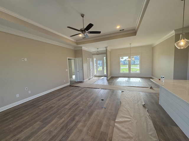 273 Springdale Dr, Crawfordville, FL 32327 - unfurnished living room featuring a raised ceiling, wood finished floors, crown molding, a chandelier, and a ceiling fan