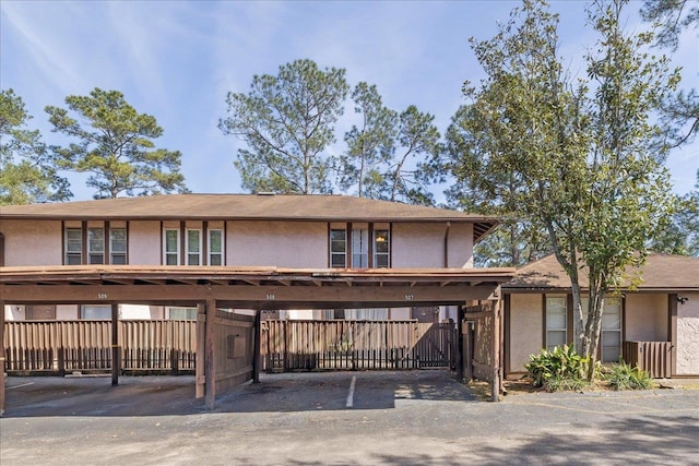 townhome / multi-family property with covered parking and stucco siding