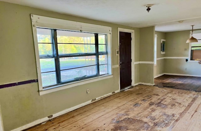 interior space with baseboards and hardwood / wood-style floors