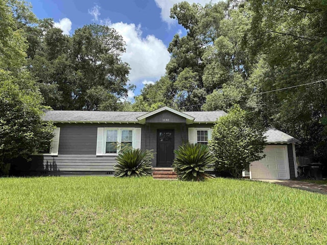 1132 Spottswood Dr, Tallahassee, FL 32308 - view of front of property featuring a front lawn, a garage, and roof with shingles