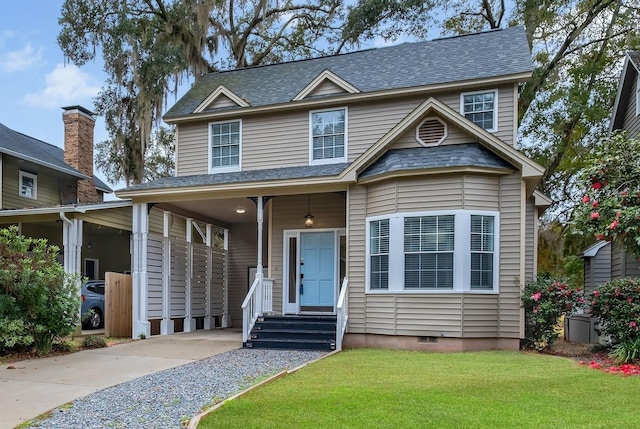 traditional home with a front lawn, crawl space, and a shingled roof