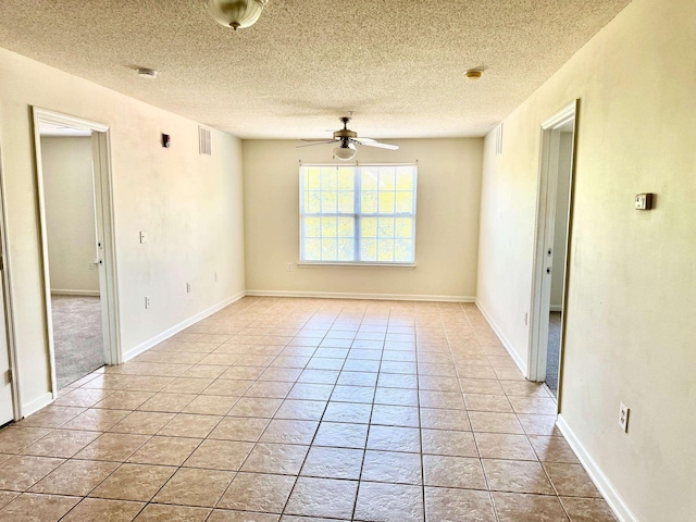 3000 S Adams St Unit 234, Tallahassee, FL 32301 - unfurnished room with ceiling fan, a textured ceiling, light tile patterned floors, baseboards, and a smoke detector