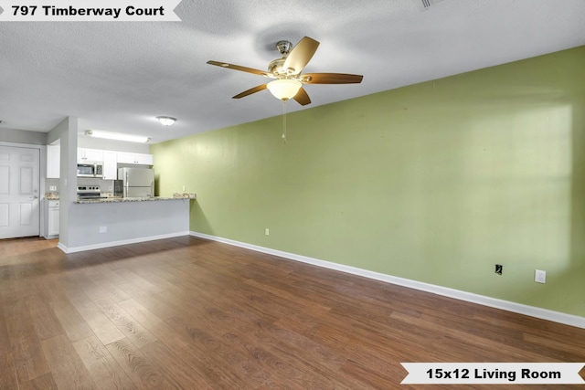 unfurnished living room featuring dark hardwood / wood-style flooring, ceiling fan, and a textured ceiling