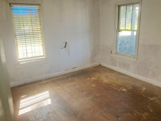 unfurnished room featuring hardwood / wood-style flooring and a wealth of natural light