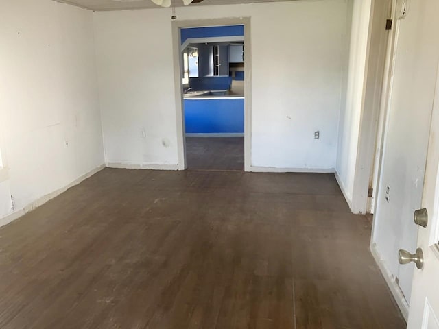 unfurnished room featuring ceiling fan and dark hardwood / wood-style flooring