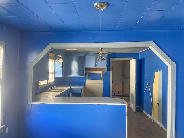 interior space featuring ceiling fan and sink