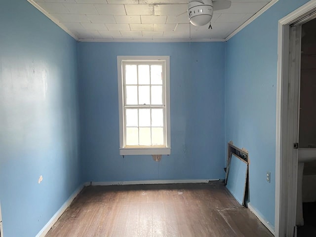 spare room featuring ornamental molding and dark wood-type flooring