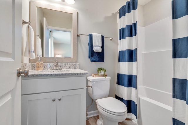 full bathroom with hardwood / wood-style flooring, vanity, toilet, and shower / bath combo with shower curtain