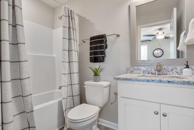 full bathroom featuring ceiling fan, shower / bathtub combination with curtain, vanity, and toilet