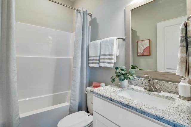 full bathroom with vanity, shower / tub combo, and toilet