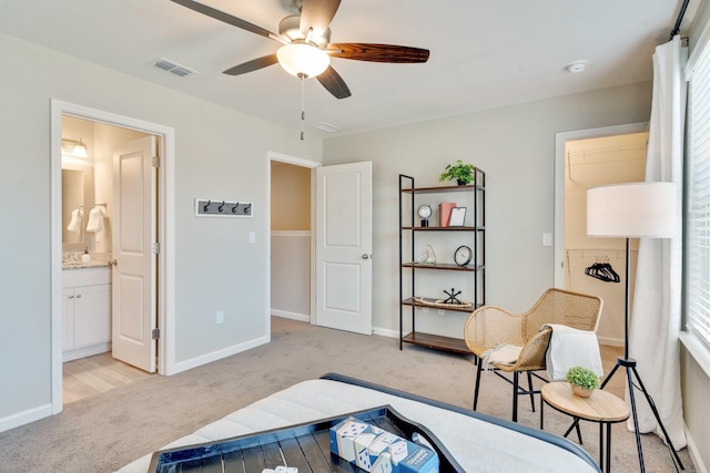 carpeted bedroom with ceiling fan and ensuite bathroom