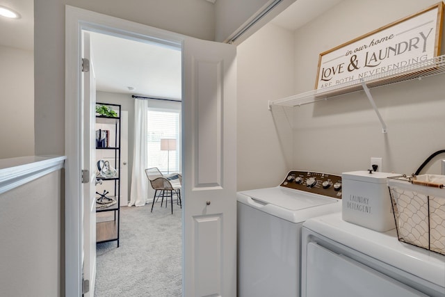 clothes washing area featuring light colored carpet and washing machine and dryer