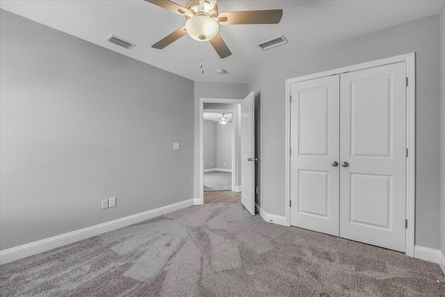 unfurnished bedroom with a closet, baseboards, visible vents, and carpet flooring
