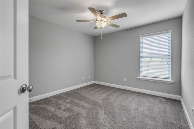 spare room featuring carpet flooring, ceiling fan, and baseboards