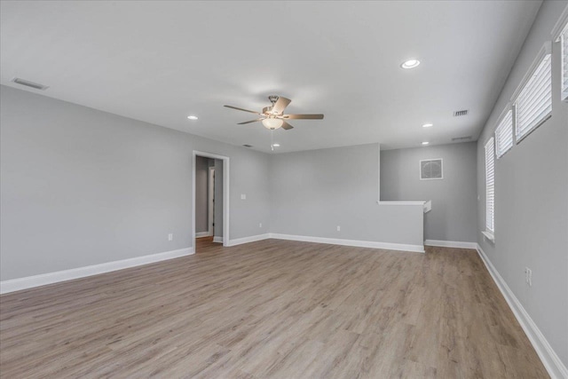 spare room featuring visible vents, recessed lighting, light wood-style flooring, and baseboards