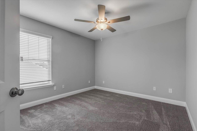 spare room featuring carpet, a ceiling fan, and baseboards