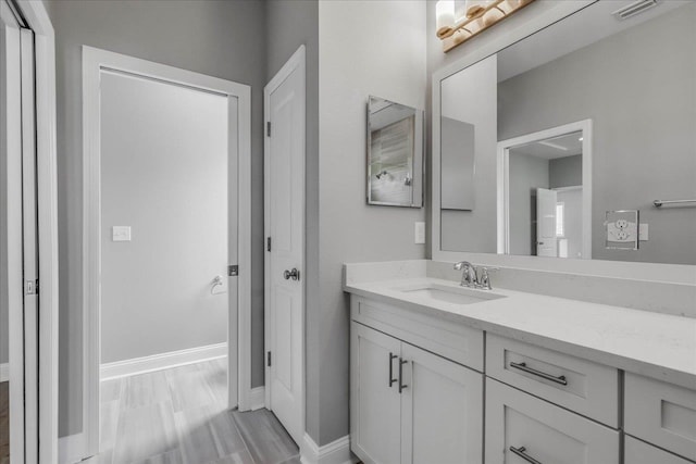 bathroom with visible vents, vanity, and baseboards