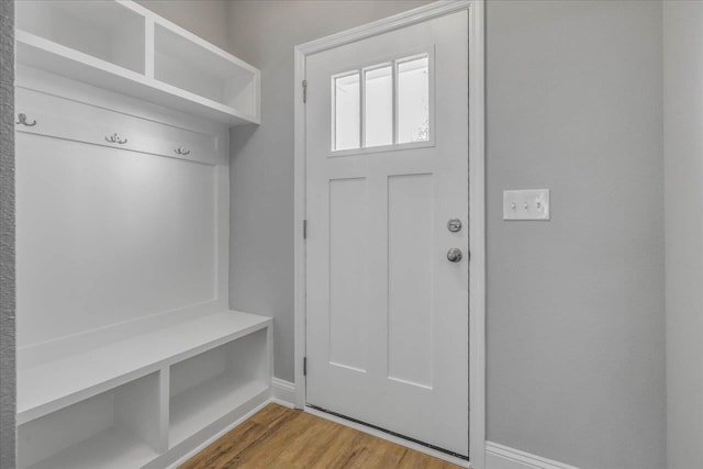 mudroom featuring baseboards and light wood finished floors