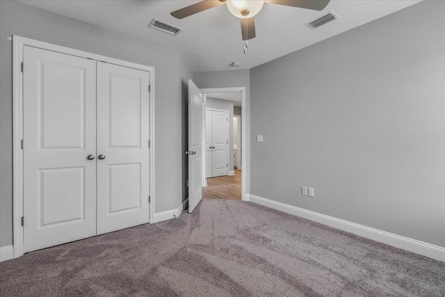 unfurnished bedroom featuring a closet, carpet flooring, visible vents, and baseboards