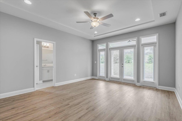 unfurnished room featuring french doors, visible vents, light wood-style floors, ceiling fan, and baseboards