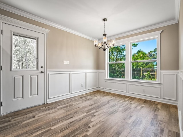 unfurnished dining area featuring a wealth of natural light, light hardwood / wood-style flooring, and an inviting chandelier