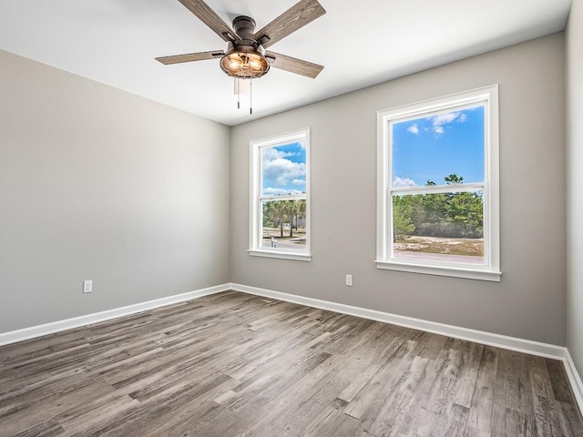 unfurnished room with ceiling fan and wood-type flooring