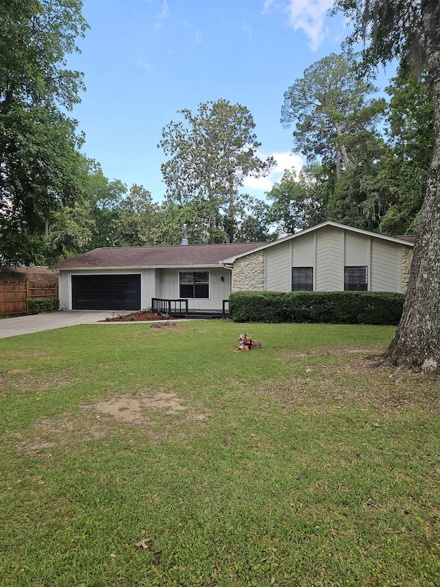 2305 Carrick Ct, Tallahassee, FL 32309 - mid-century home featuring a front yard, a garage, and driveway
