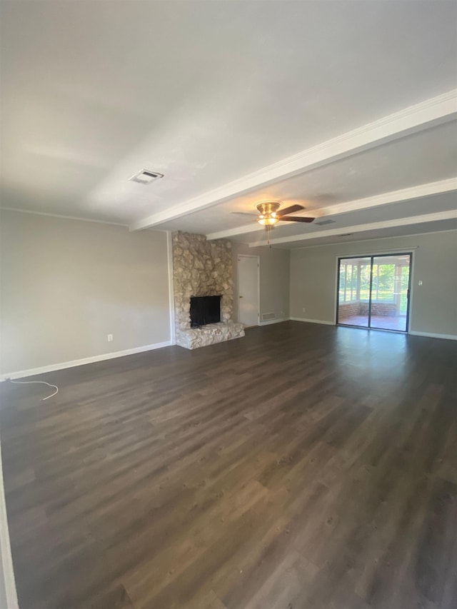 2305 Carrick Ct, Tallahassee, FL 32309 - unfurnished living room with beam ceiling, baseboards, dark wood-type flooring, a ceiling fan, and a stone fireplace