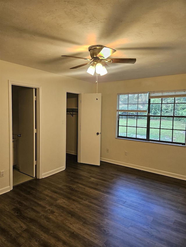 2305 Carrick Ct, Tallahassee, FL 32309 - unfurnished bedroom with dark wood-type flooring, baseboards, a closet, and a textured ceiling