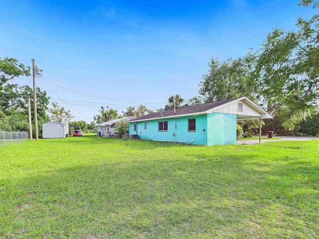 302 Goff St, Perry, FL 32347 - rear view of house with a carport, driveway, and a shed