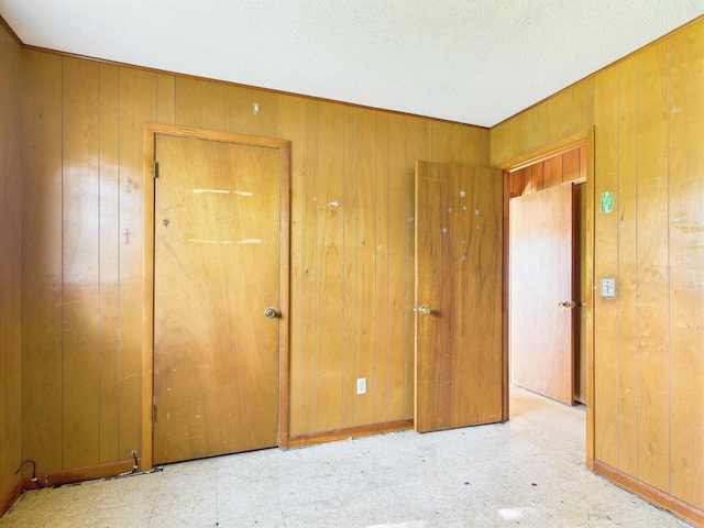 302 Goff St, Perry, FL 32347 - unfurnished room featuring wood walls and tile patterned floors