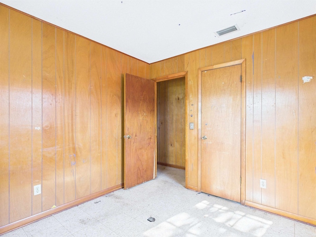 302 Goff St, Perry, FL 32347 - spare room featuring wooden walls and tile patterned floors