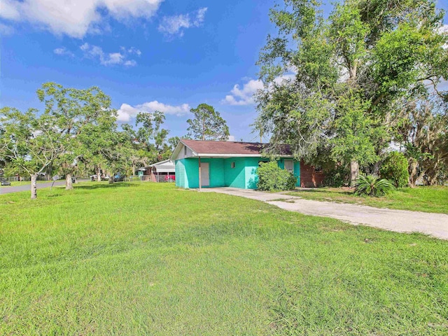 302 Goff St, Perry, FL 32347 - view of front of home with driveway, a carport, and a front yard