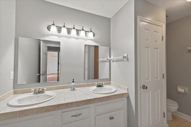 2965 N Shamrock, Tallahassee, FL 32309 - bathroom featuring double vanity, tile patterned floors, and a closet