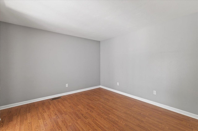 2965 N Shamrock, Tallahassee, FL 32309 - unfurnished room with wood finished floors and baseboards