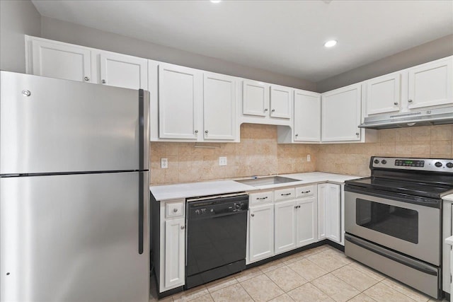2965 N Shamrock, Tallahassee, FL 32309 - kitchen with stainless steel appliances, under cabinet range hood, light countertops, white cabinetry, and recessed lighting