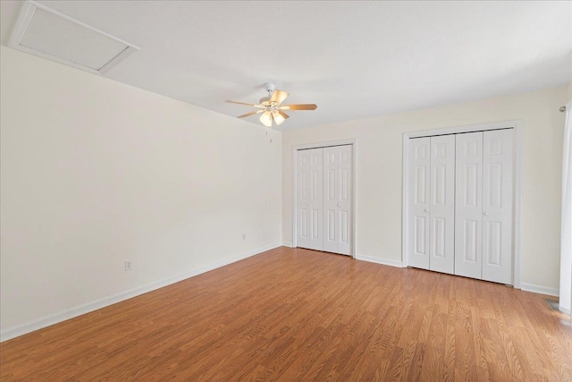 2965 N Shamrock, Tallahassee, FL 32309 - unfurnished bedroom with light wood finished floors, multiple closets, and a ceiling fan